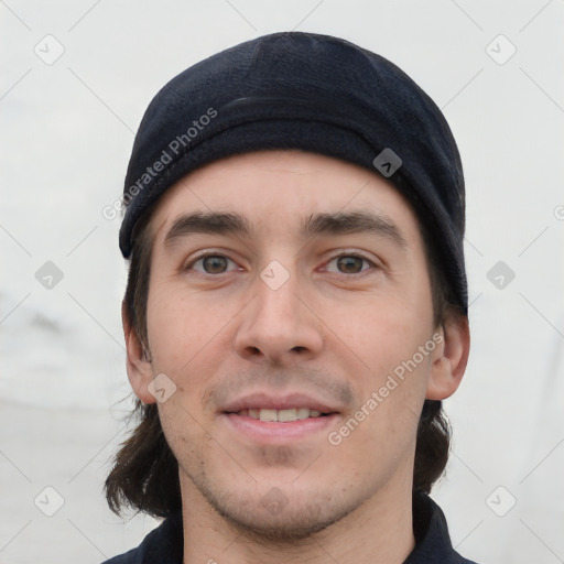 Joyful white young-adult male with short  black hair and brown eyes