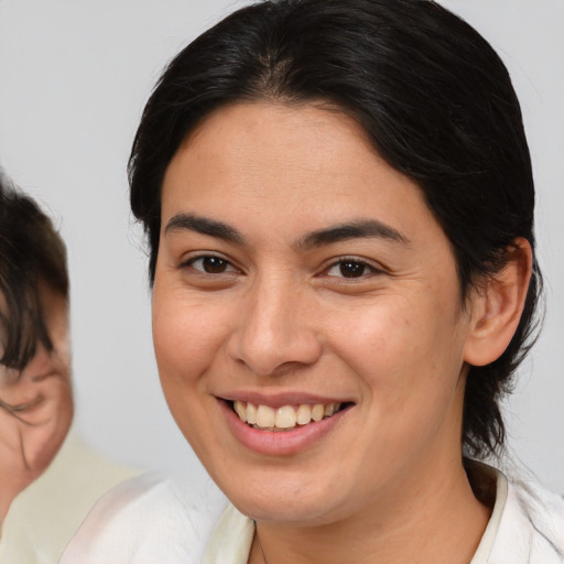 Joyful white young-adult female with medium  brown hair and brown eyes