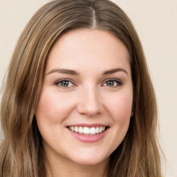 Joyful white young-adult female with long  brown hair and green eyes