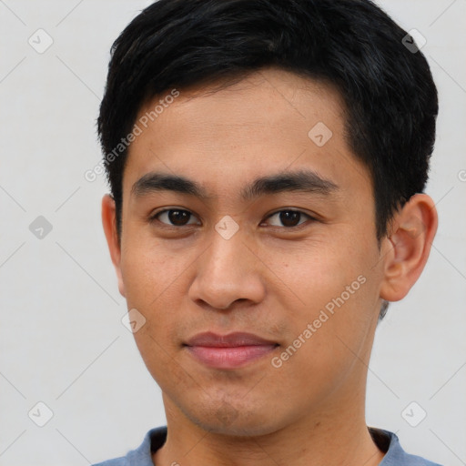 Joyful asian young-adult male with short  brown hair and brown eyes