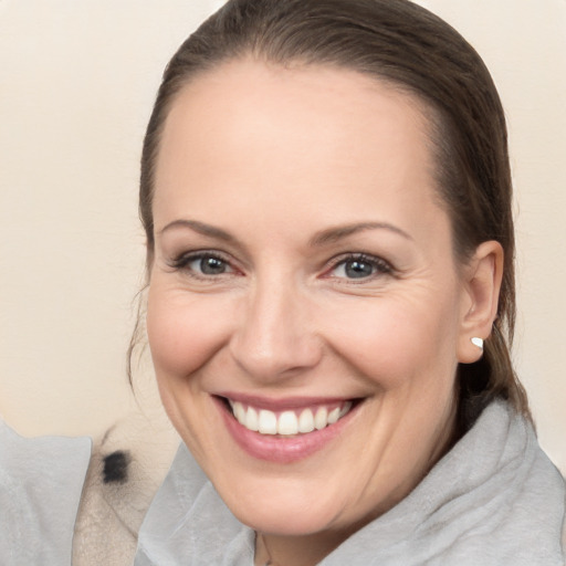 Joyful white adult female with medium  brown hair and brown eyes