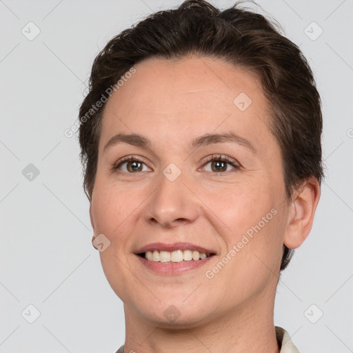 Joyful white adult female with short  brown hair and grey eyes