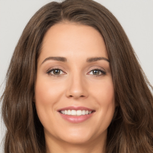 Joyful white young-adult female with long  brown hair and brown eyes