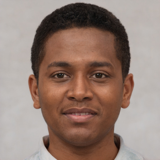 Joyful latino young-adult male with short  brown hair and brown eyes