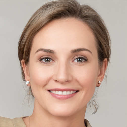 Joyful white young-adult female with medium  brown hair and grey eyes