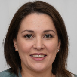 Joyful white adult female with medium  brown hair and brown eyes