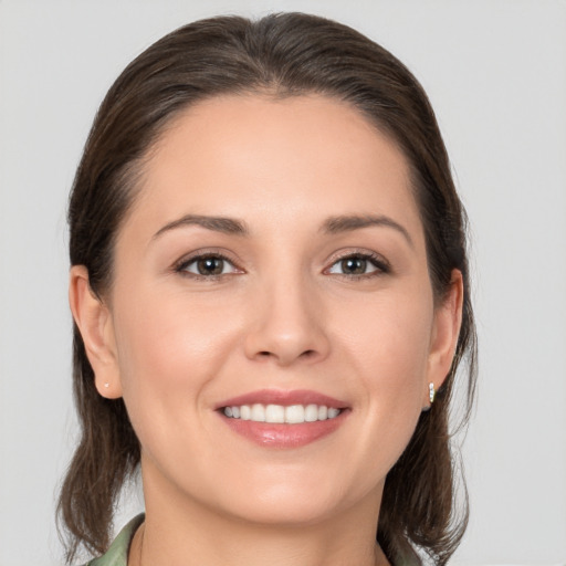 Joyful white young-adult female with medium  brown hair and brown eyes