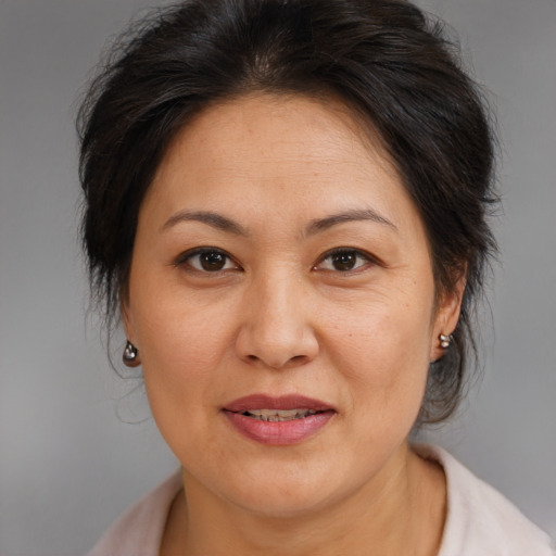Joyful asian adult female with medium  brown hair and brown eyes