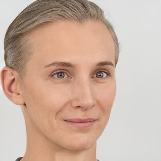 Joyful white adult female with short  brown hair and grey eyes