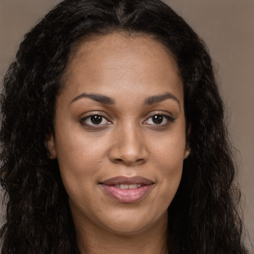 Joyful latino young-adult female with long  brown hair and brown eyes