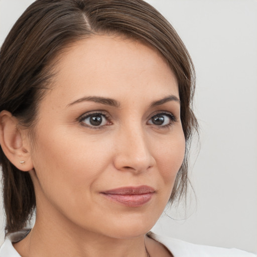 Joyful white young-adult female with medium  brown hair and brown eyes