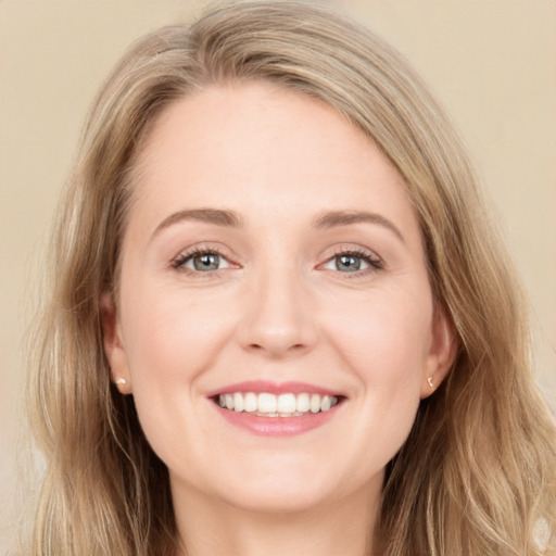 Joyful white young-adult female with long  brown hair and blue eyes