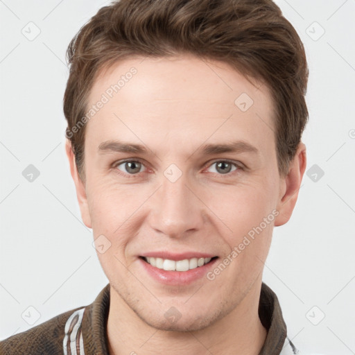 Joyful white young-adult male with short  brown hair and grey eyes