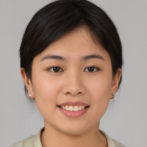 Joyful asian young-adult female with medium  brown hair and brown eyes