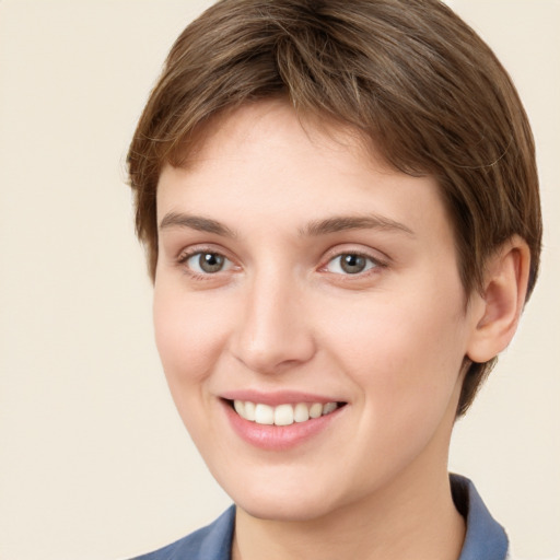 Joyful white young-adult female with short  brown hair and grey eyes