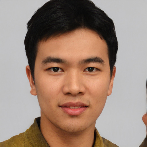 Joyful asian young-adult male with short  black hair and brown eyes