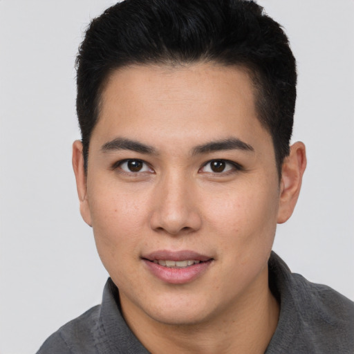 Joyful asian young-adult male with short  brown hair and brown eyes