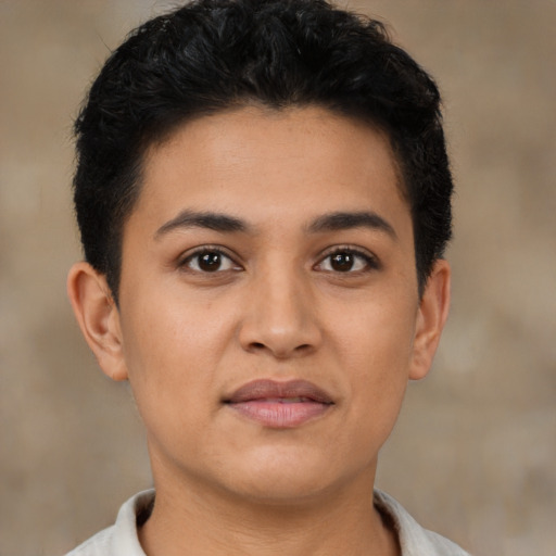 Joyful latino young-adult female with short  black hair and brown eyes