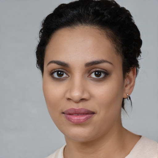 Joyful latino young-adult female with medium  black hair and brown eyes