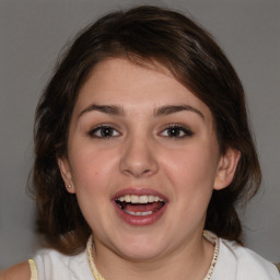 Joyful white young-adult female with medium  brown hair and blue eyes