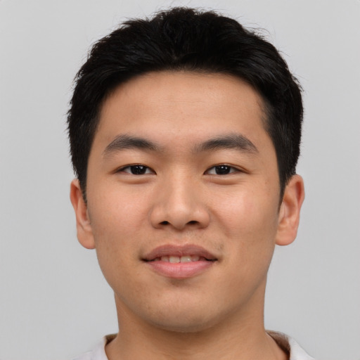 Joyful asian young-adult male with short  brown hair and brown eyes