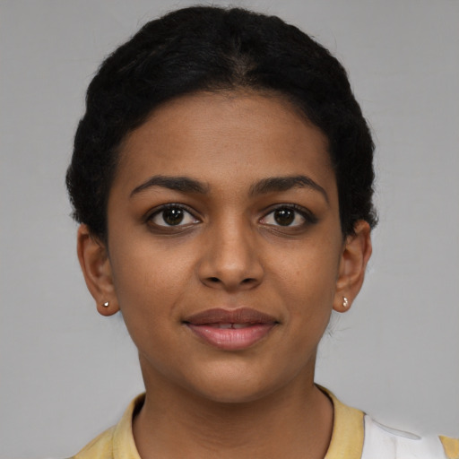 Joyful black young-adult female with short  black hair and brown eyes