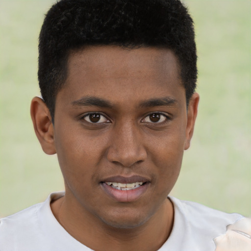 Joyful black young-adult male with short  brown hair and brown eyes