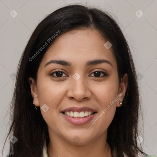 Joyful latino young-adult female with long  brown hair and brown eyes