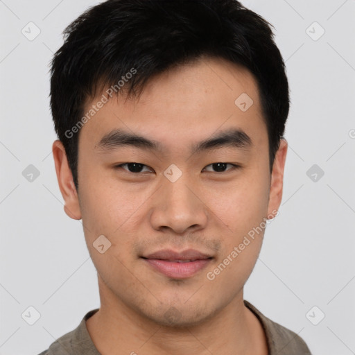 Joyful asian young-adult male with short  black hair and brown eyes