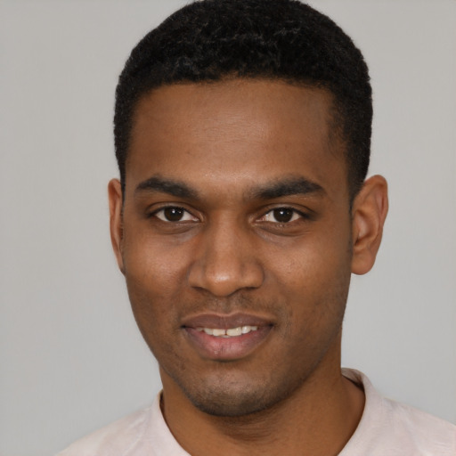 Joyful black young-adult male with short  black hair and brown eyes