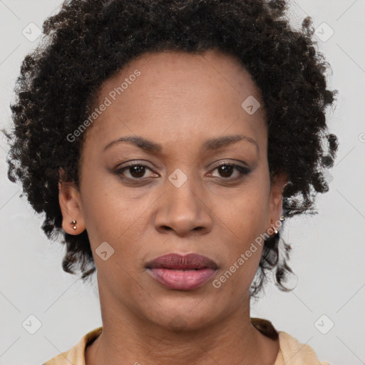 Joyful black adult female with short  brown hair and brown eyes