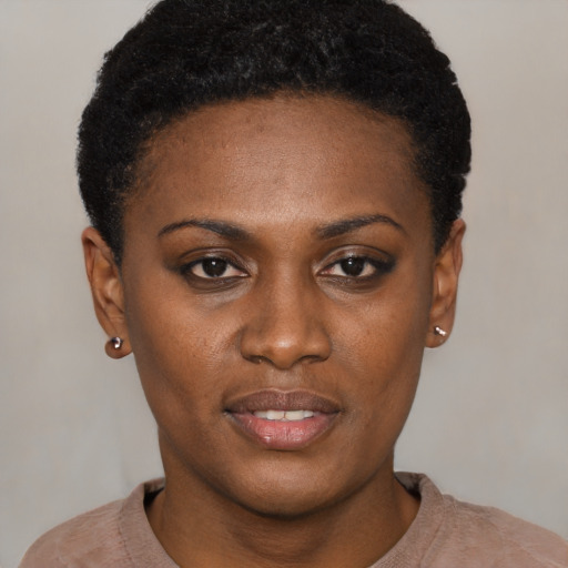 Joyful black young-adult female with short  black hair and brown eyes