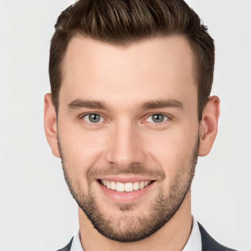 Joyful white young-adult male with short  brown hair and grey eyes