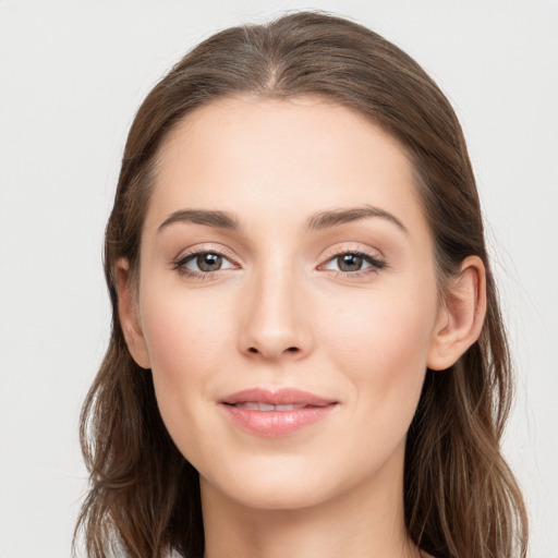 Joyful white young-adult female with long  brown hair and grey eyes