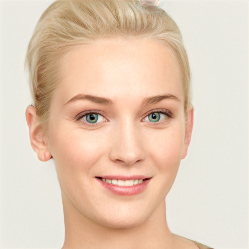 Joyful white young-adult female with short  blond hair and blue eyes