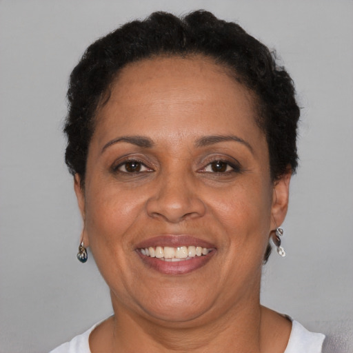 Joyful black adult female with short  brown hair and brown eyes