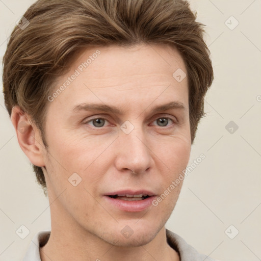 Joyful white adult male with short  brown hair and grey eyes