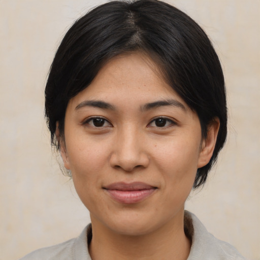 Joyful asian young-adult female with medium  brown hair and brown eyes