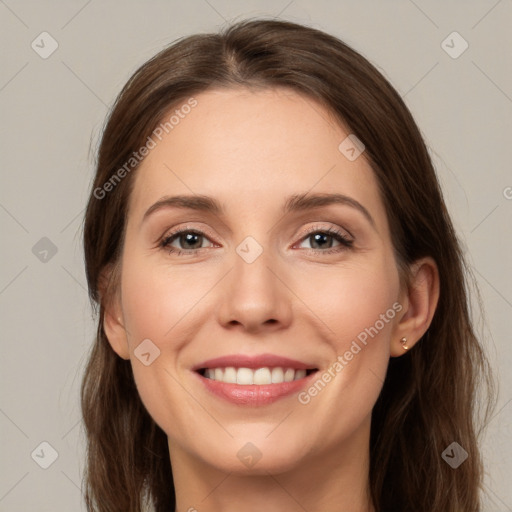 Joyful white young-adult female with long  brown hair and grey eyes