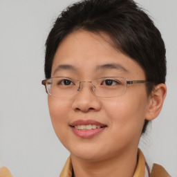Joyful asian young-adult female with short  brown hair and brown eyes
