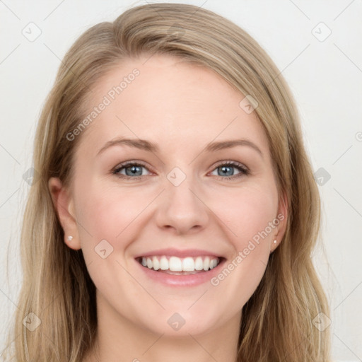 Joyful white young-adult female with long  brown hair and blue eyes