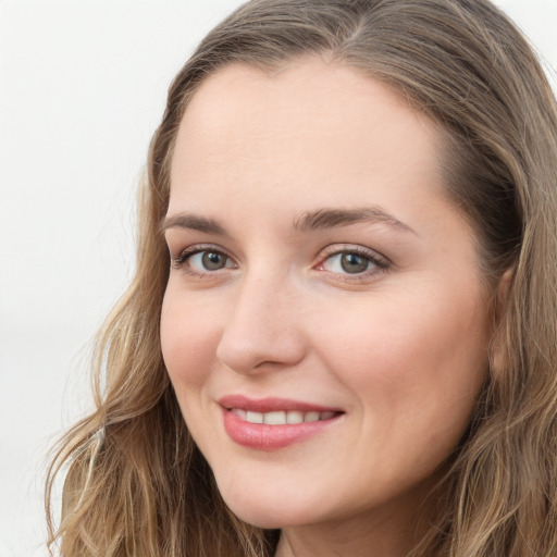 Joyful white young-adult female with long  brown hair and green eyes