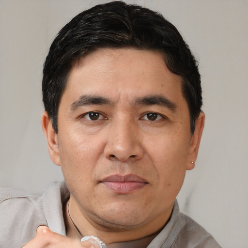 Joyful white adult male with short  brown hair and brown eyes