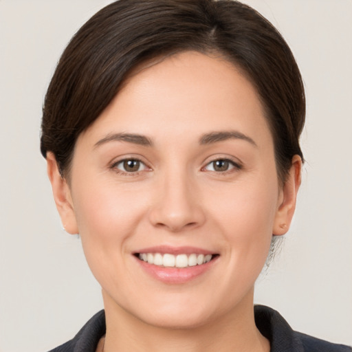 Joyful white young-adult female with short  brown hair and brown eyes