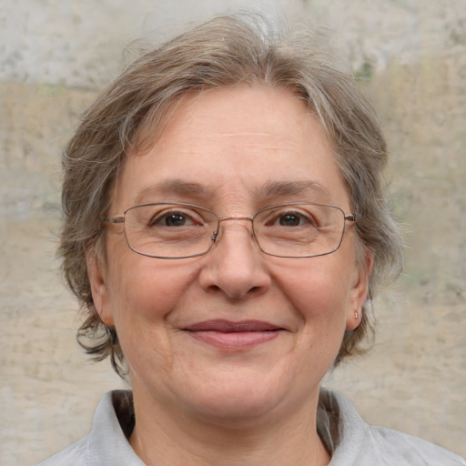 Joyful white middle-aged female with medium  brown hair and grey eyes