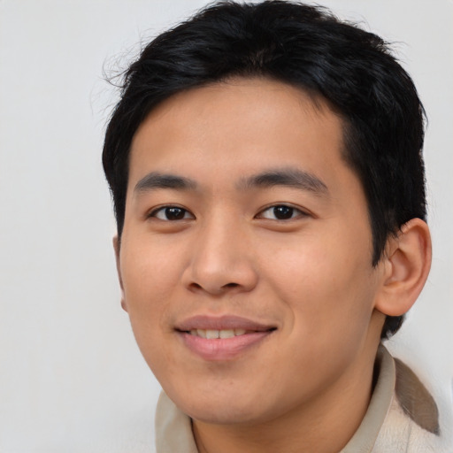 Joyful asian young-adult male with short  black hair and brown eyes