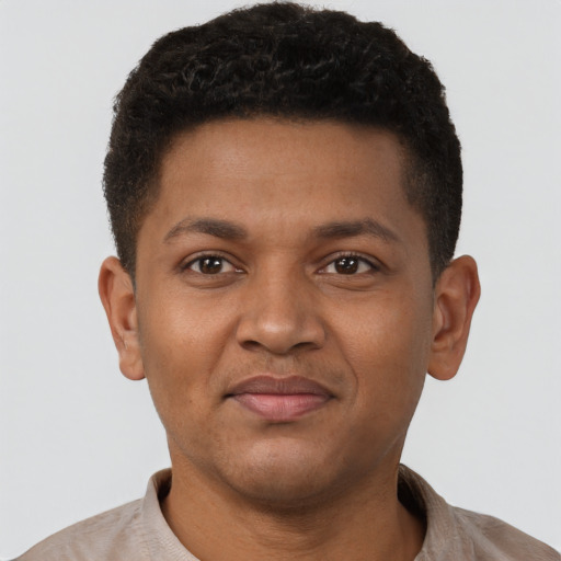 Joyful latino young-adult male with short  brown hair and brown eyes