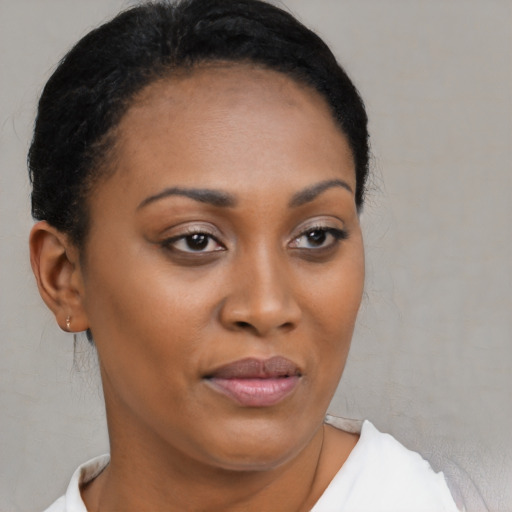 Joyful black young-adult female with short  brown hair and brown eyes