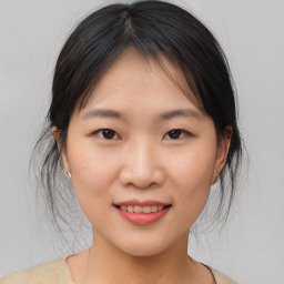 Joyful asian young-adult female with medium  brown hair and brown eyes