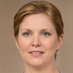 Joyful white adult female with medium  brown hair and grey eyes